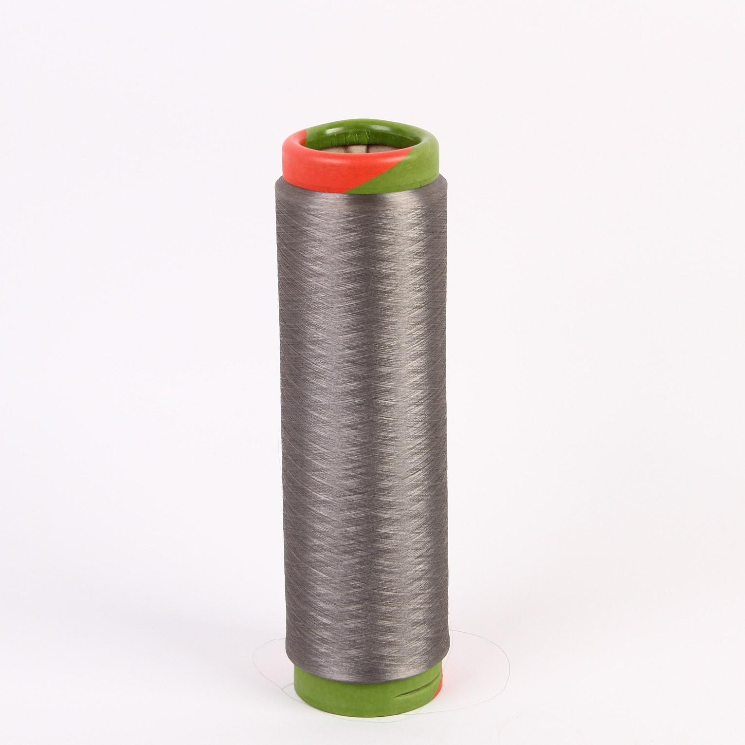 Spool of silver-plated conductive yarn on a white background