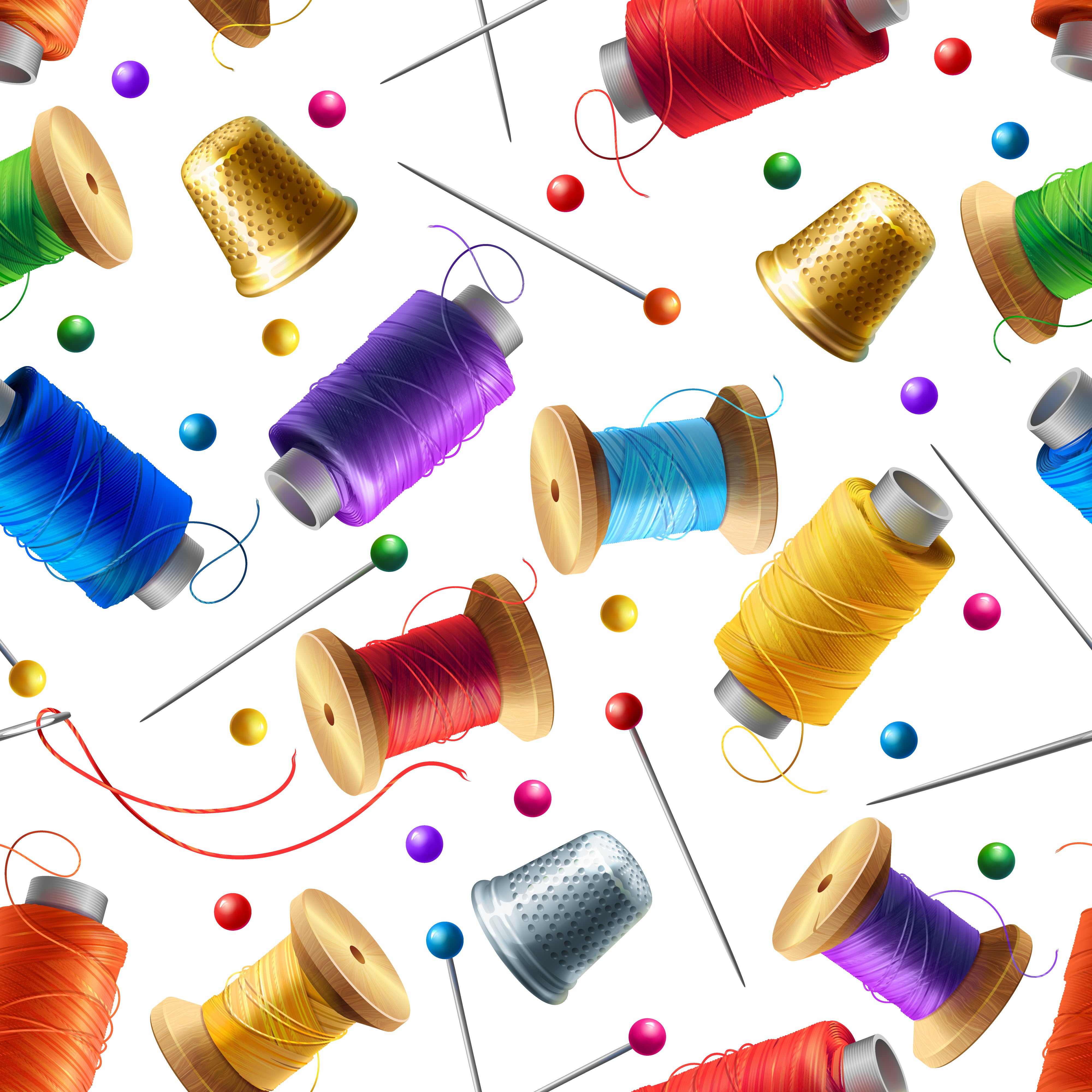 Colorful sewing-thread spools and needles on a white background