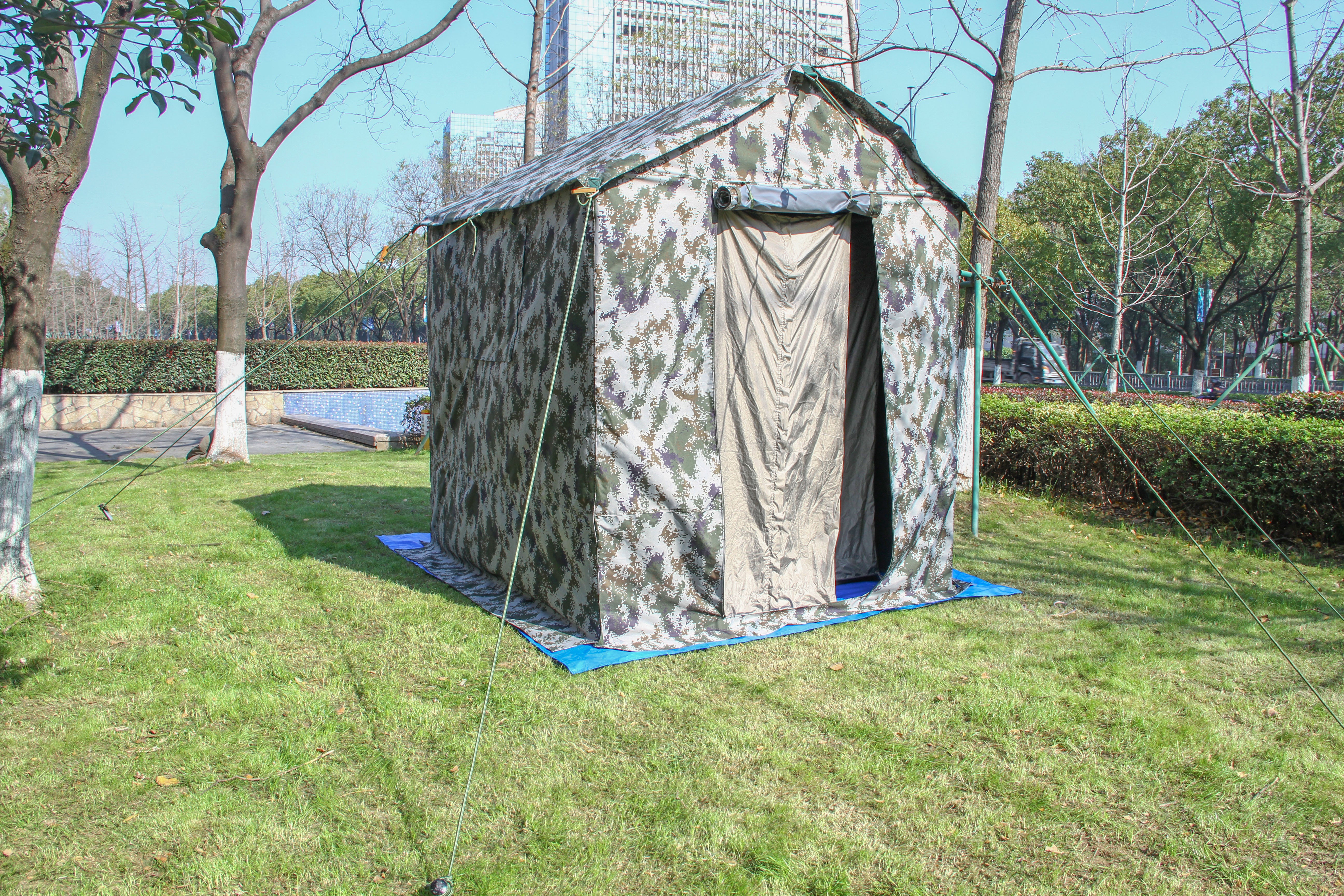 Camouflage Faraday tent standing outdoors on grass