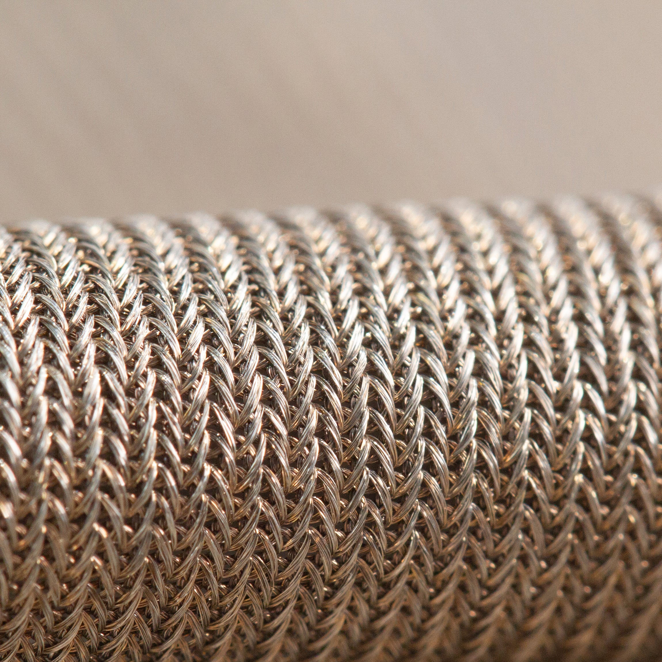 Close-up of silver-plated knitted fabric with interlocking loops
