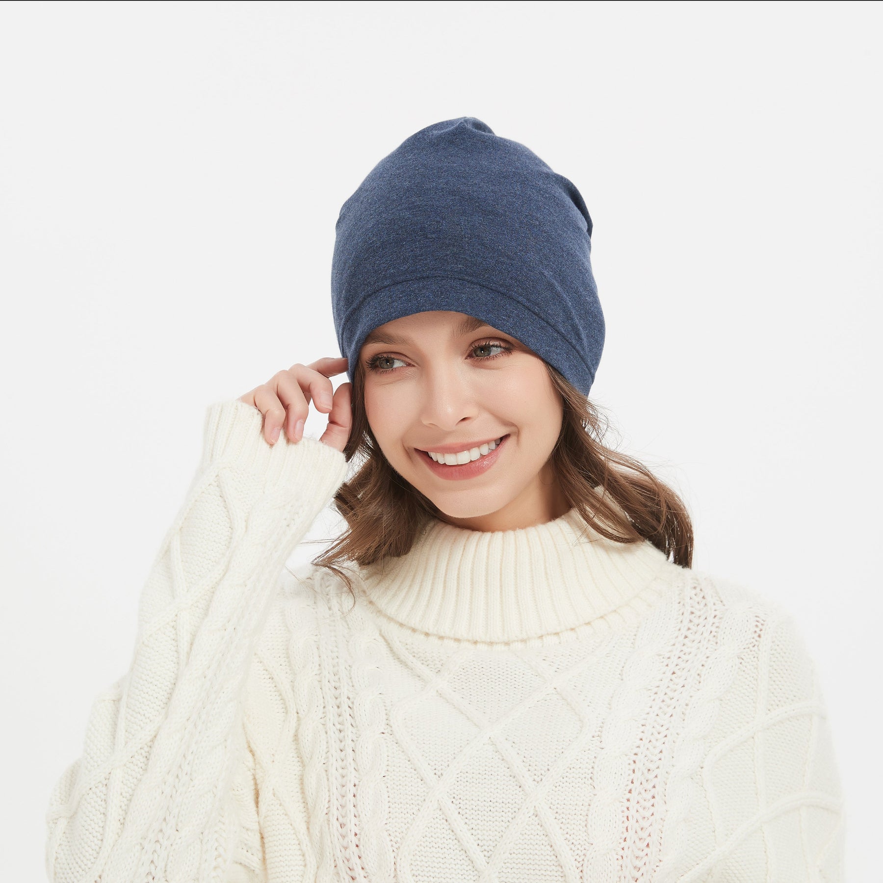 A women is happy about her new EMF beanie hat in heather navy color