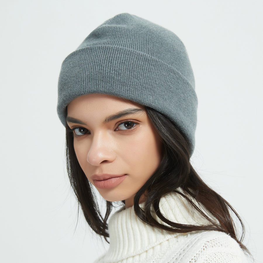 Woman wearing a warm silver-fiber RF shielding winter beanie