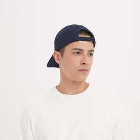 A male model is wearing EMF Shielding Baseball Cap backwards