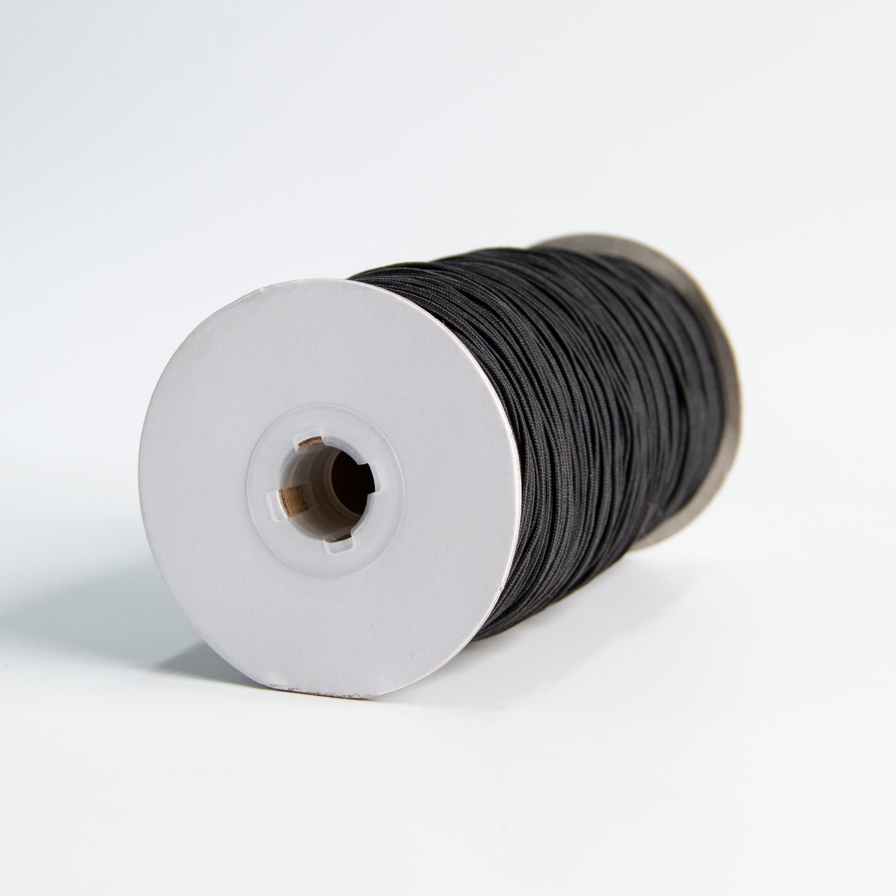 Sideview of silver conductive elastic cable in cone