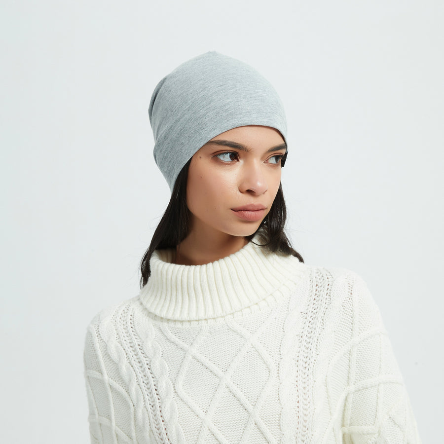 Woman wearing a lightweight grey silver-fiber RF shielding beanie