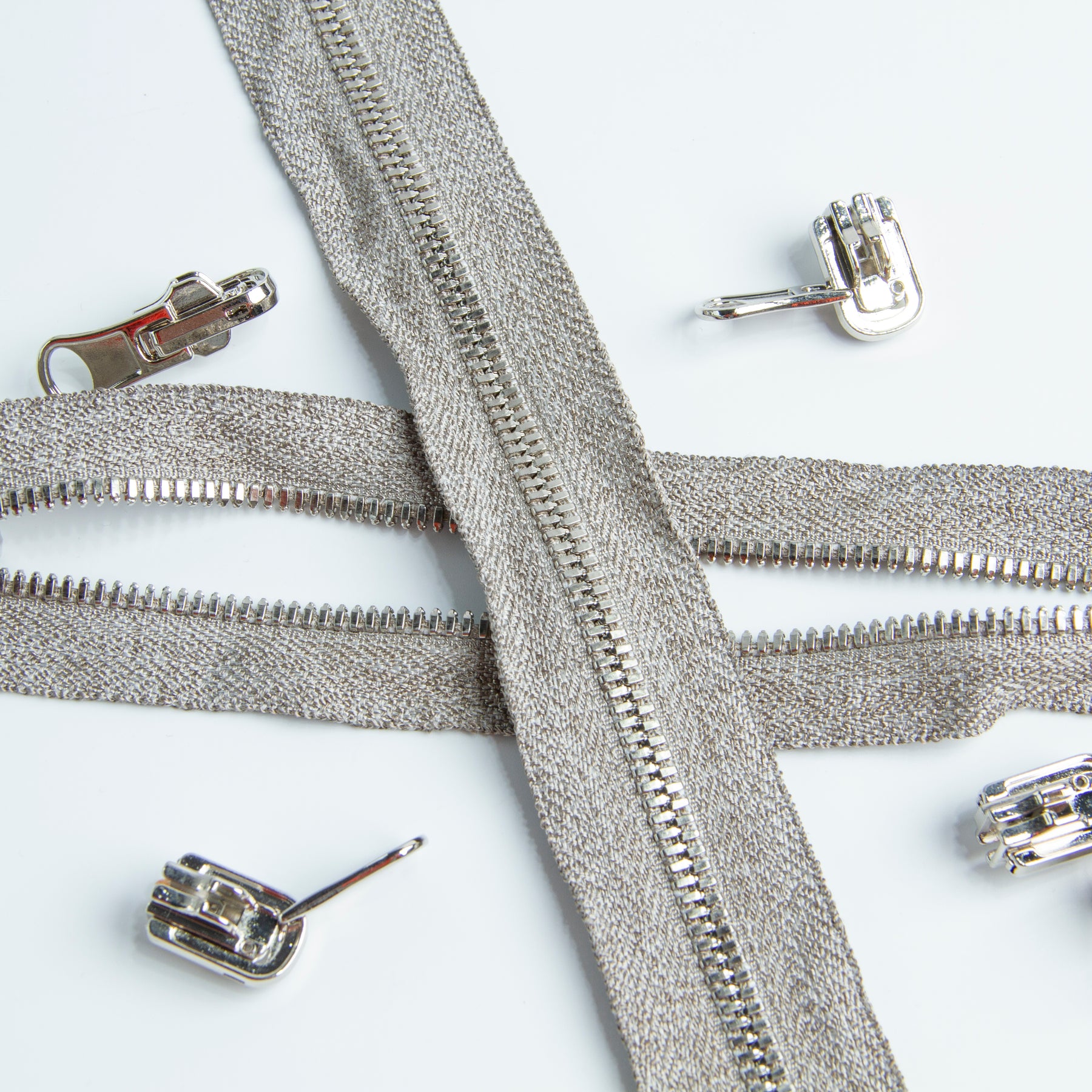 Two Silver Plated Conductive Zipper cross each other, one tape is open, the other tape is closed