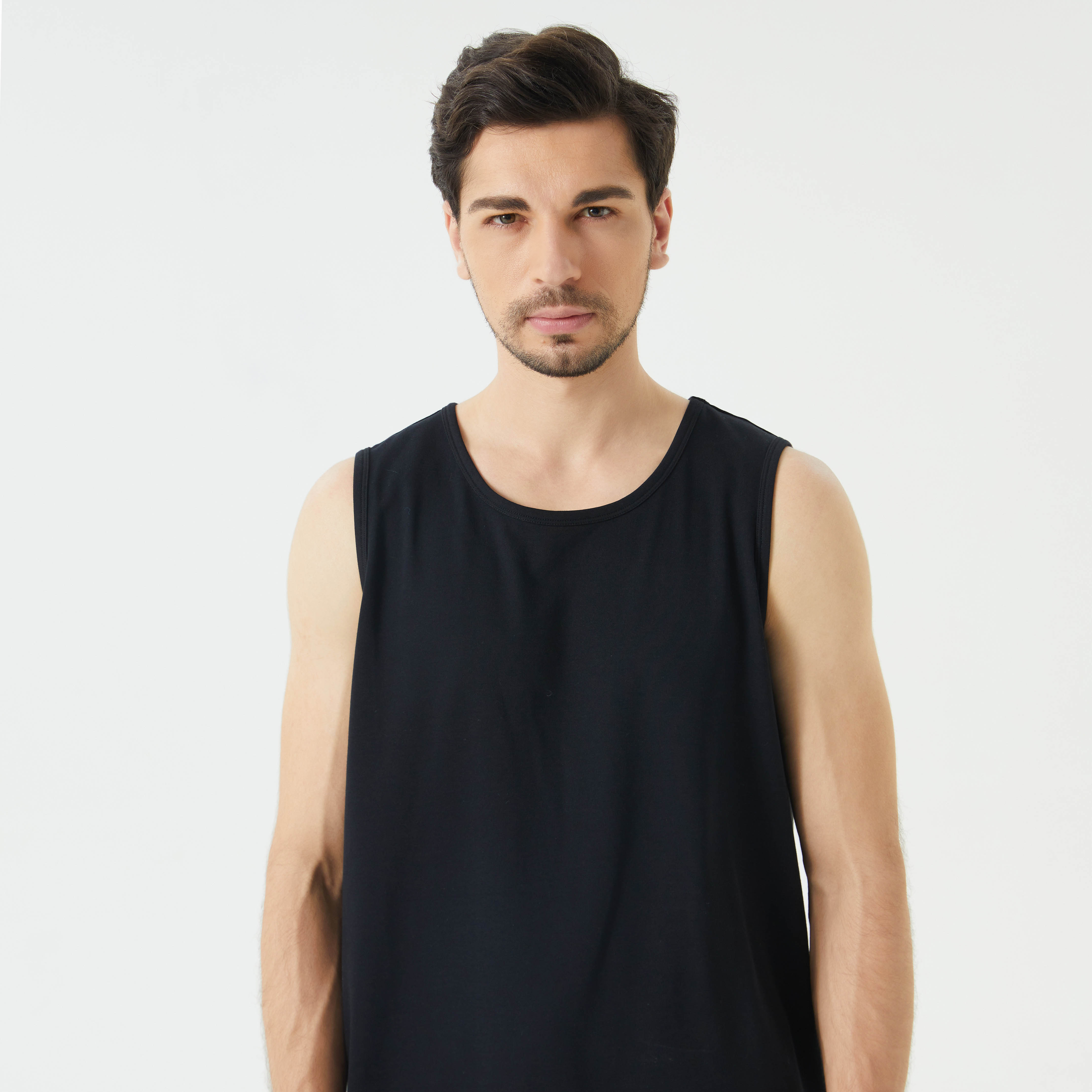 Male model wearing a EMF tank top in black color