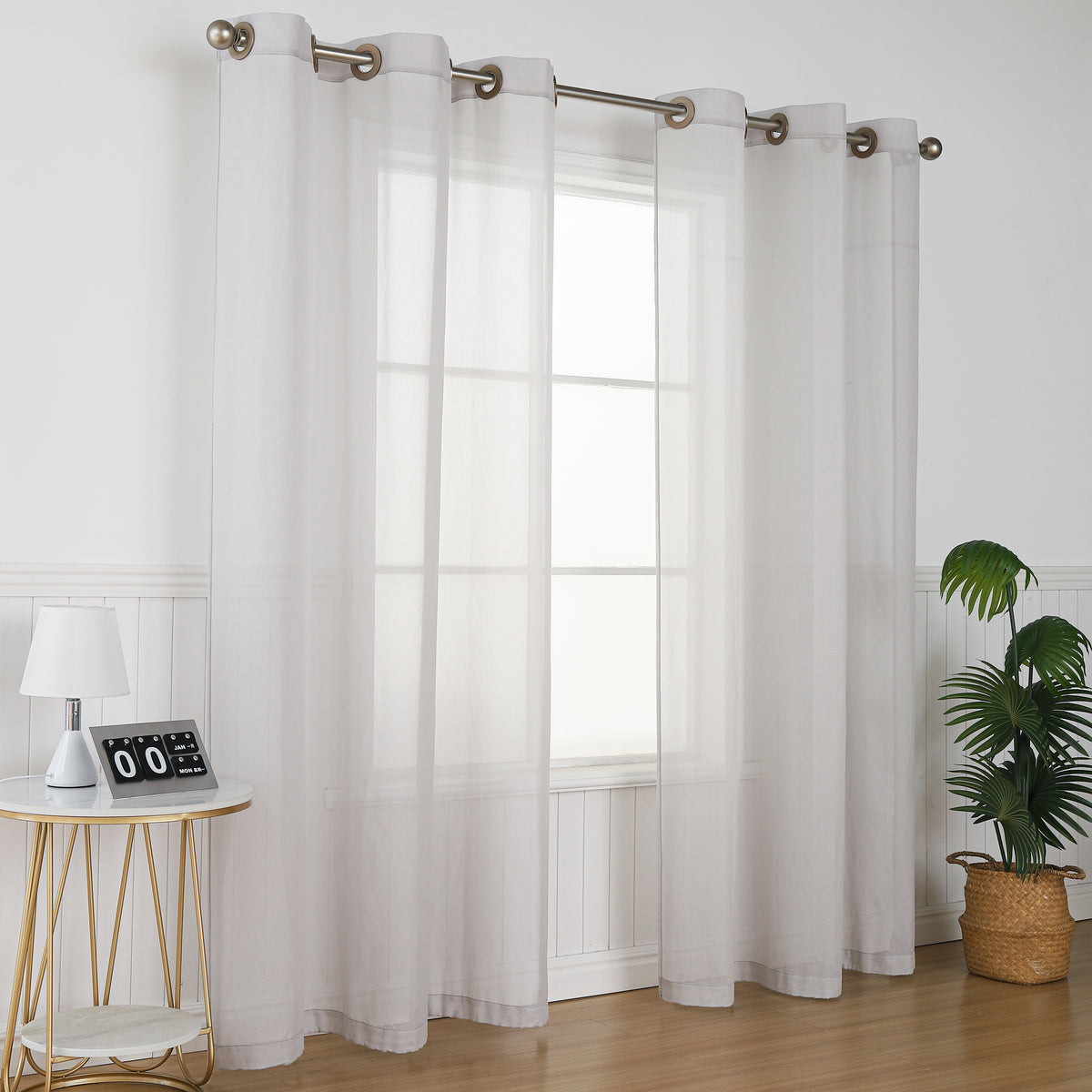 Curtain panels hanging at a window, angled room view