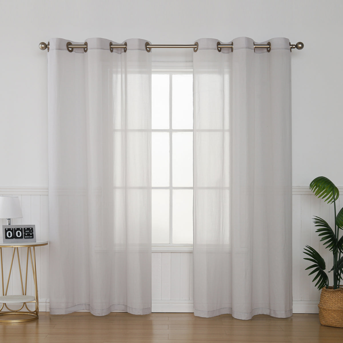 Silver fiber organic cotton curtain panels hanging at a window, full front view