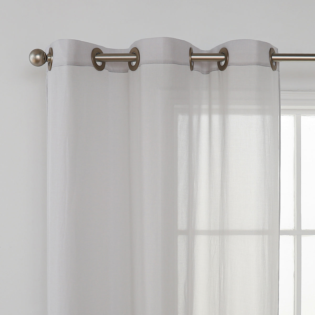 Curtain panel header threaded onto a curtain rod