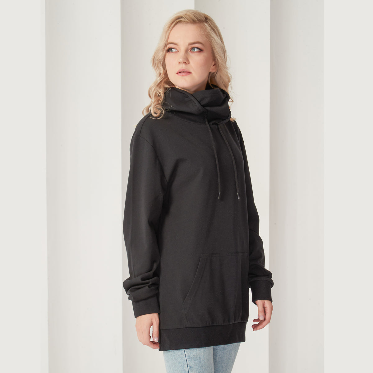 Black pullover hoodie with attached face mask lowered, angled view
